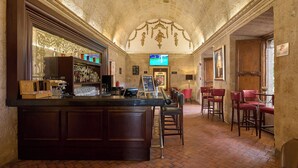 A bar area with a counter, stools, and a television screen. - Casa Andina Premium Arequipa (Arequipa)