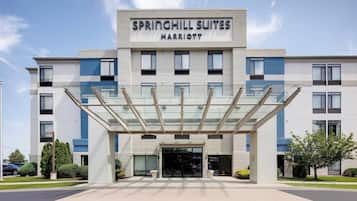 A modern hotel with a glass entrance canopy, labeled "Springhill Suites Marriott."