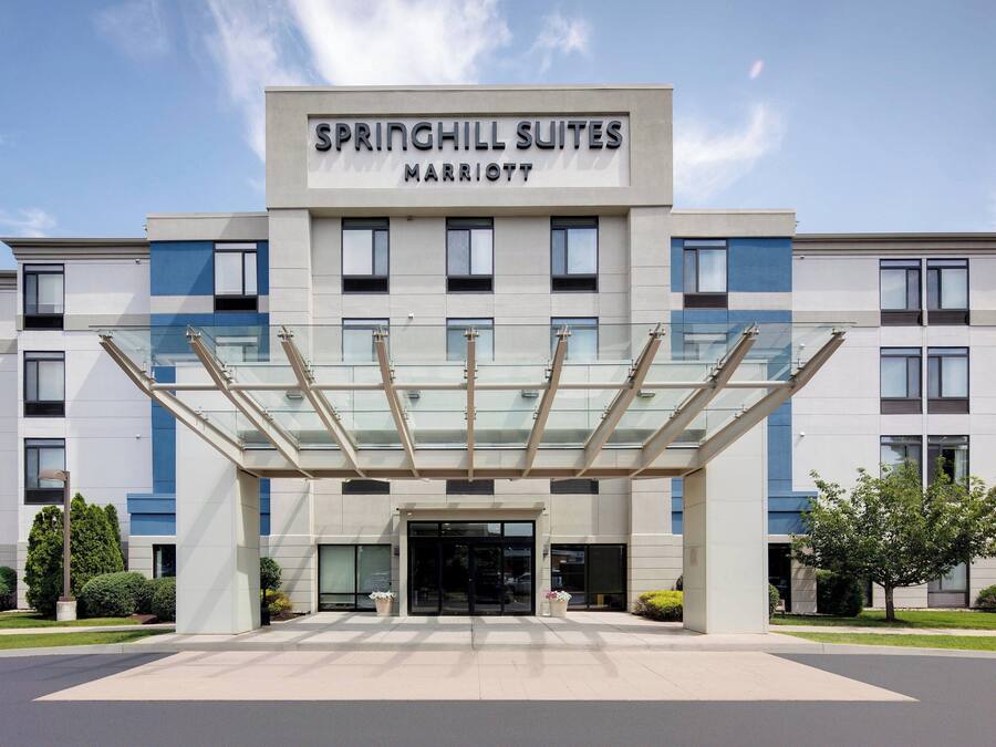 A modern hotel with a glass entrance canopy, labeled "Springhill Suites Marriott."