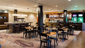 A modern restaurant with a bar area, multiple seating options, and a visible menu board. - Courtyard Marriott Lafayette (Lafayette)