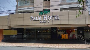 The Palm Hotel in Manila with a prominent sign and a staircase leading to the entrance. - Palm Hotel Manila (Manila)