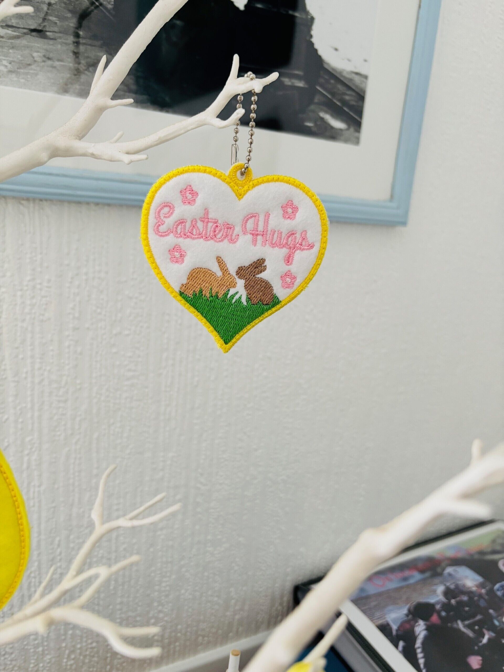 A heart-shaped ornament with "Easter Hugs" and bunny silhouettes.