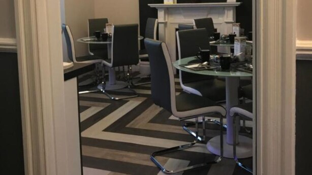 A modern office space with two desks, chairs, and a decorative wall piece. - Cassandra Guest House (Plymouth)