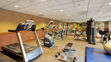 A gym with treadmills, elliptical machines, and weight equipment.