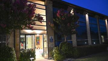 A building with large windows, a glass door entrance, and a sign indicating 'Best Western.'