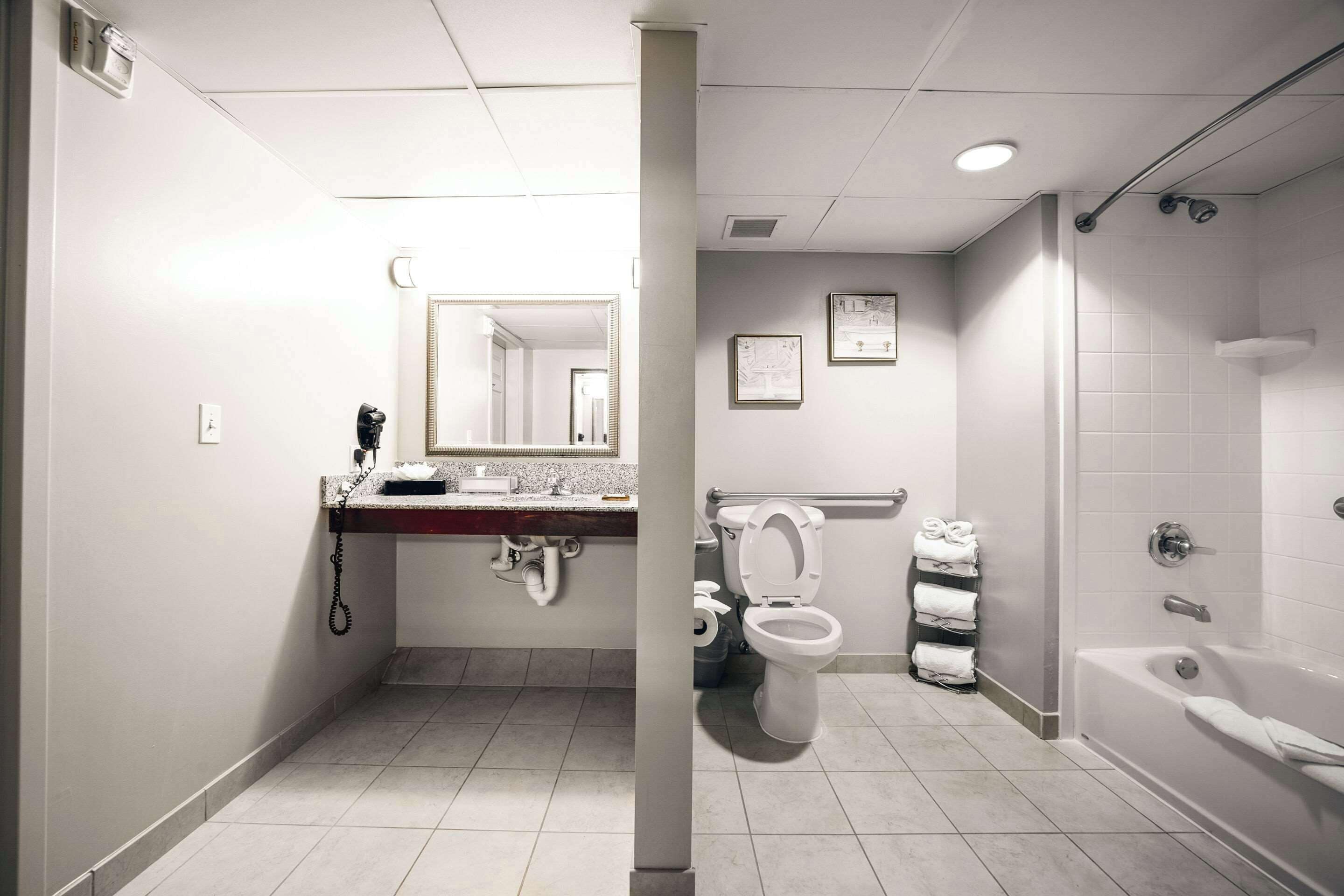 A modern bathroom with a toilet, sink, and bathtub.