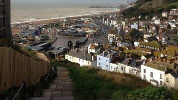 A coastal town with a prominent pier, a beach, and a mix of residential and commercial buildings.