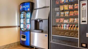 Máquina expendedora de Pepsi y otra con diferentes paquetes de papas fritas.