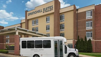 Ein weißes Hotelgebäude der Sprinchill Suites Marriott mit einem weißen Lieferwagen davor.