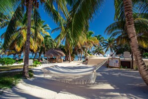 Na praia, espreguiçadeiras, toalhas de praia, massagens na praia 
