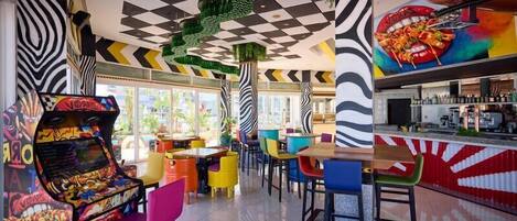 A vibrant arcade with colorful gaming machines, a bar area with a red and white striped counter, and a variety of seating options.