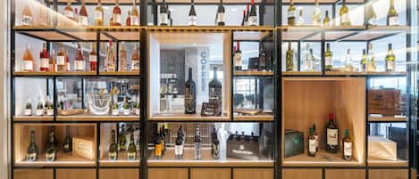 A wine and liquor store with multiple shelves and glass cases displaying various bottles.