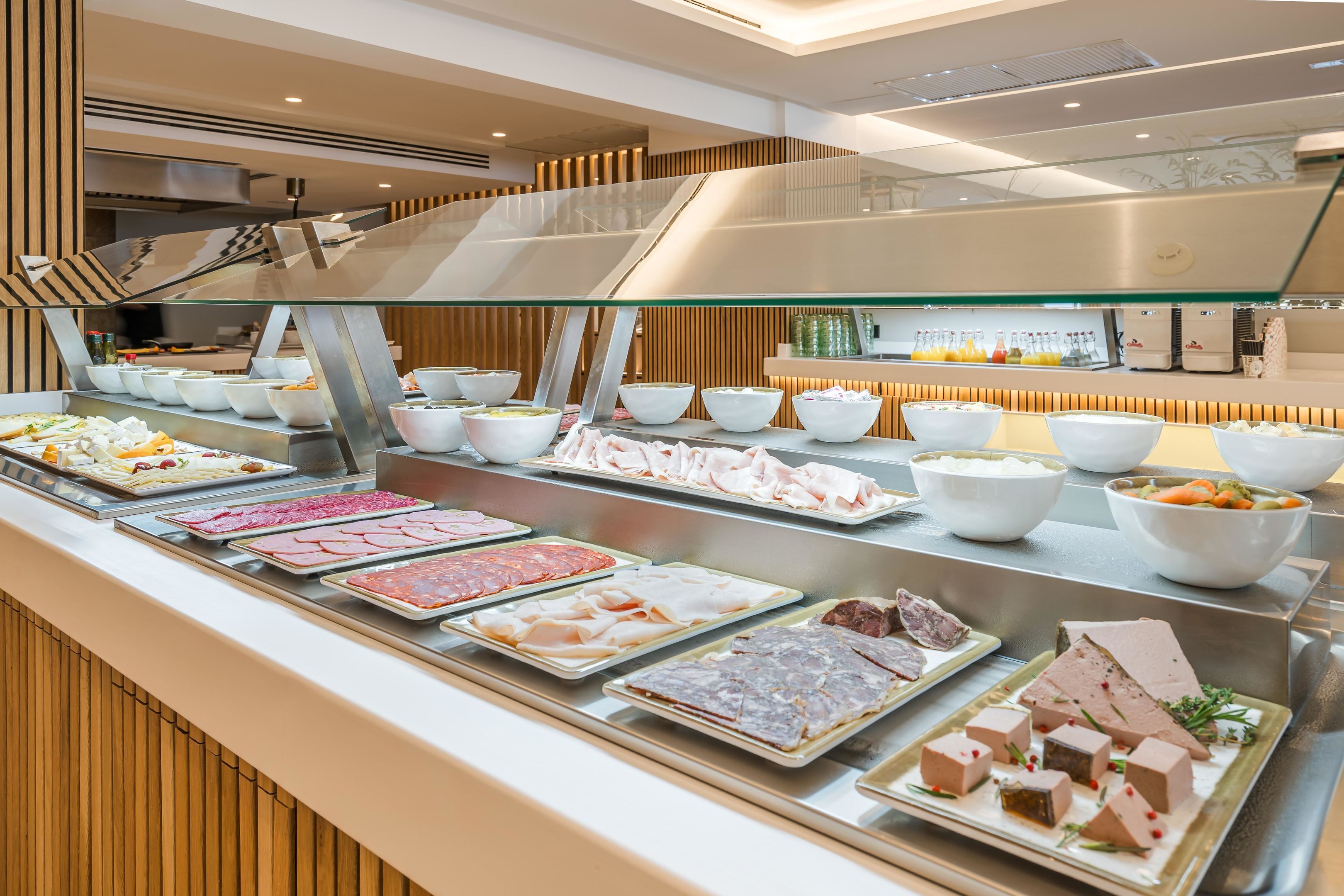 A buffet with various meats and salads.
