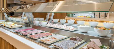 A buffet with various meats and salads.