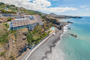 On the beach, black sand, beach towels
