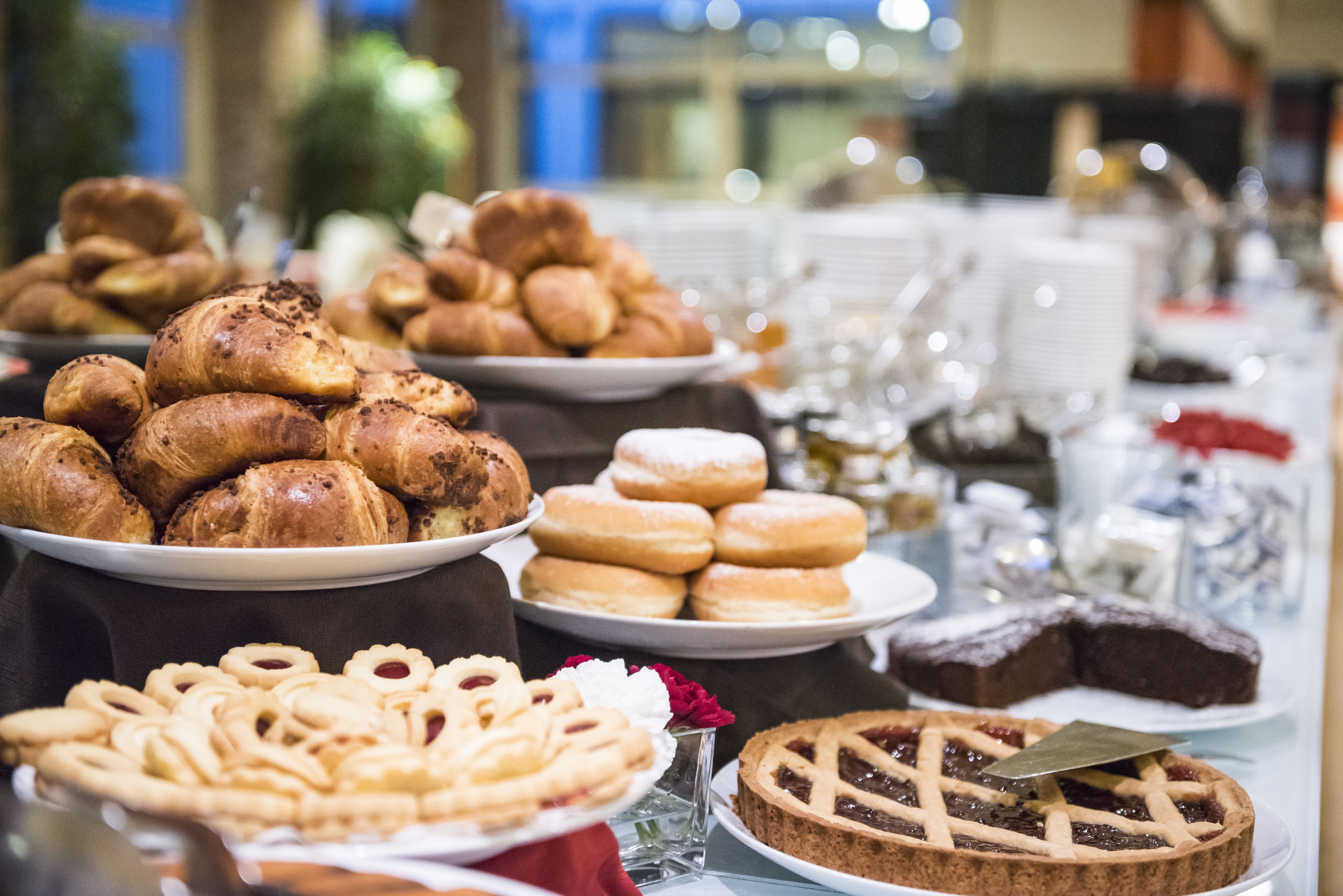 A buffet with various pastries and desserts.