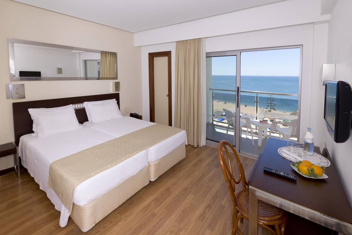 Twin Room, Partial Sea View | Minibar, in-room safe, free WiFi, bed sheets