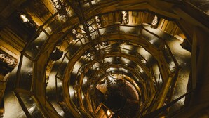 Una escalera de caracol con detalles metálicos y barandillas de madera.