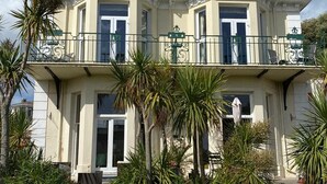 A large, two-story building with a balcony and a well-maintained lawn. - The Torcroft (Torquay)