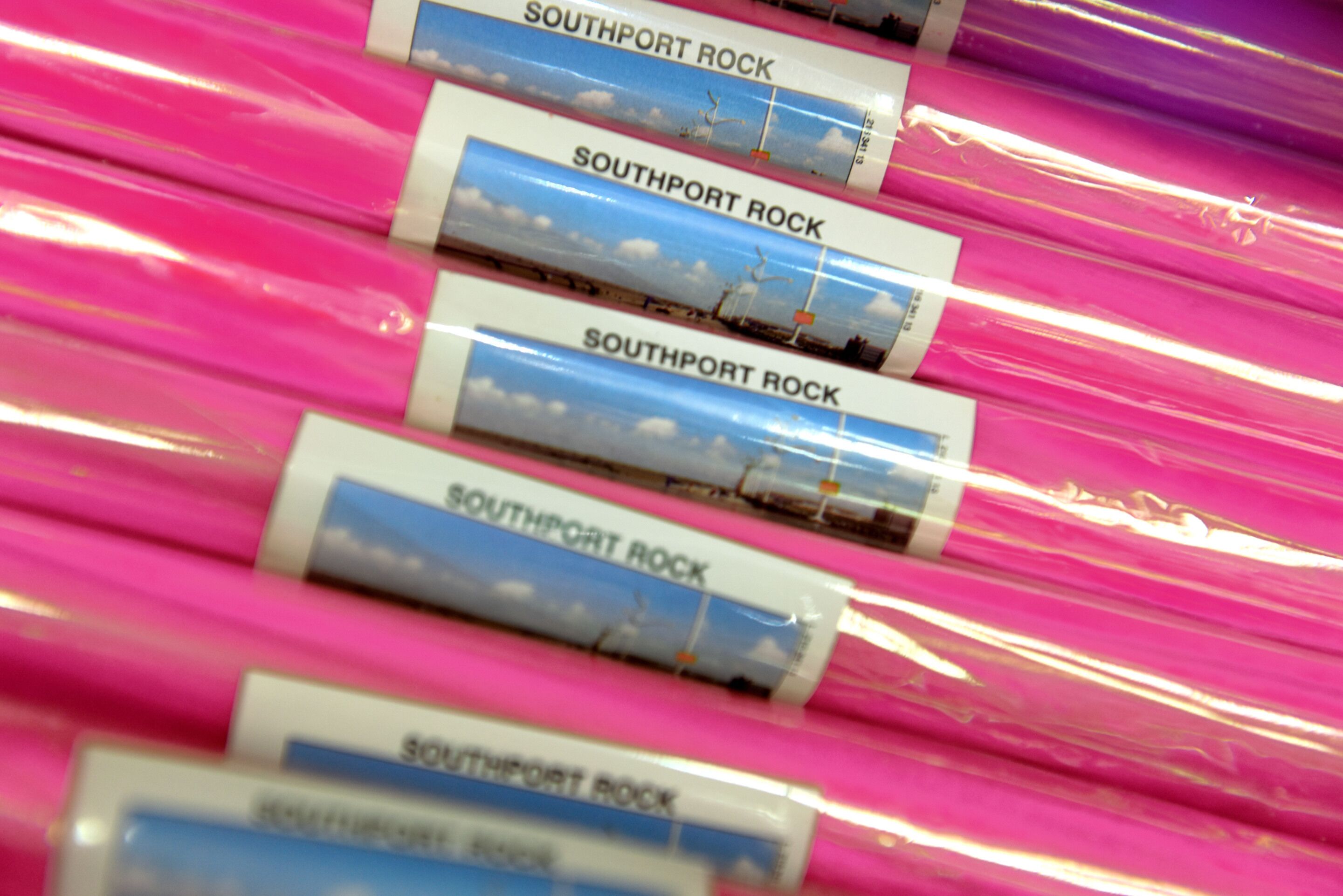 A series of pink and white striped packages with the text "Southport Rock" on them.