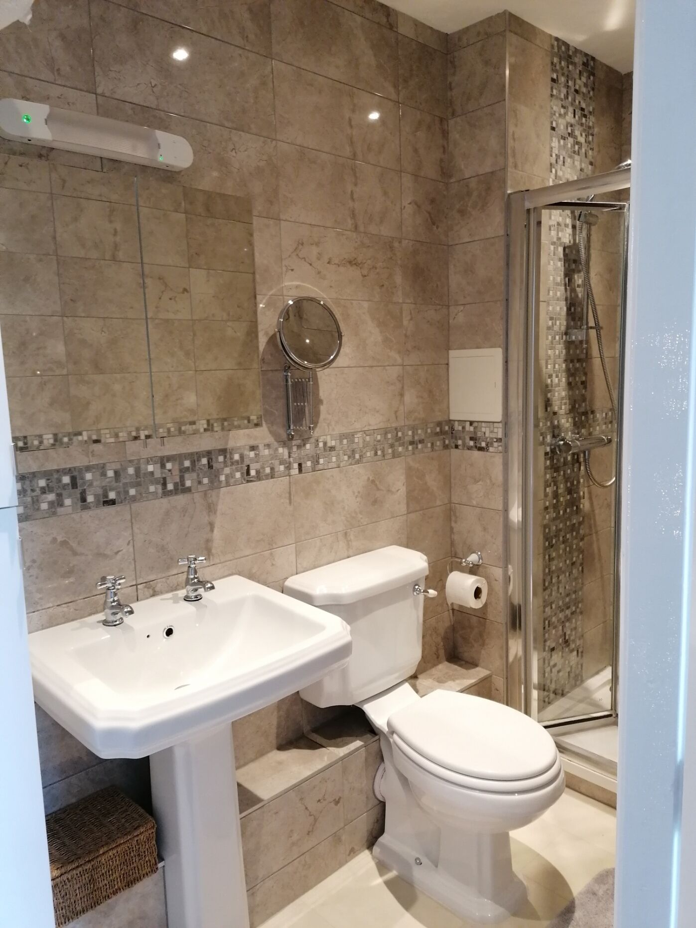 A bathroom with a sink, toilet, and shower.
