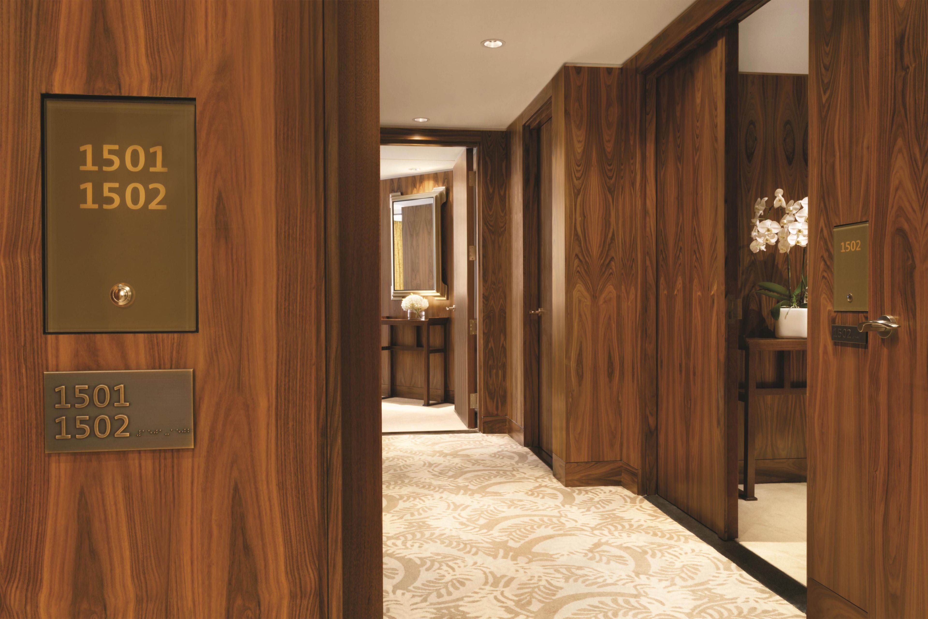 A hallway with wooden paneling and numbered doors labeled 1501 and 1502.