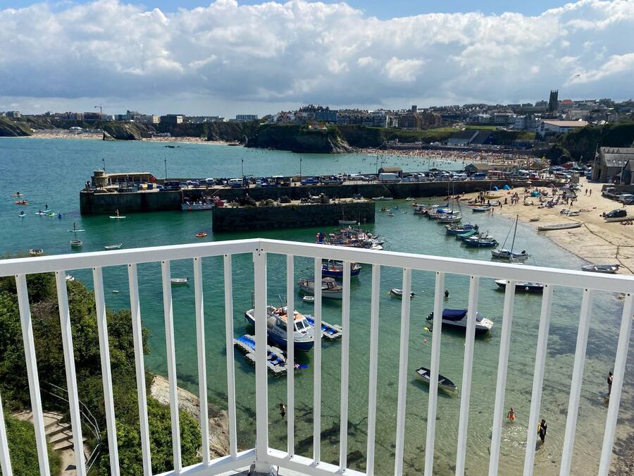 A coastal town with a marina, beach, and buildings in the background.