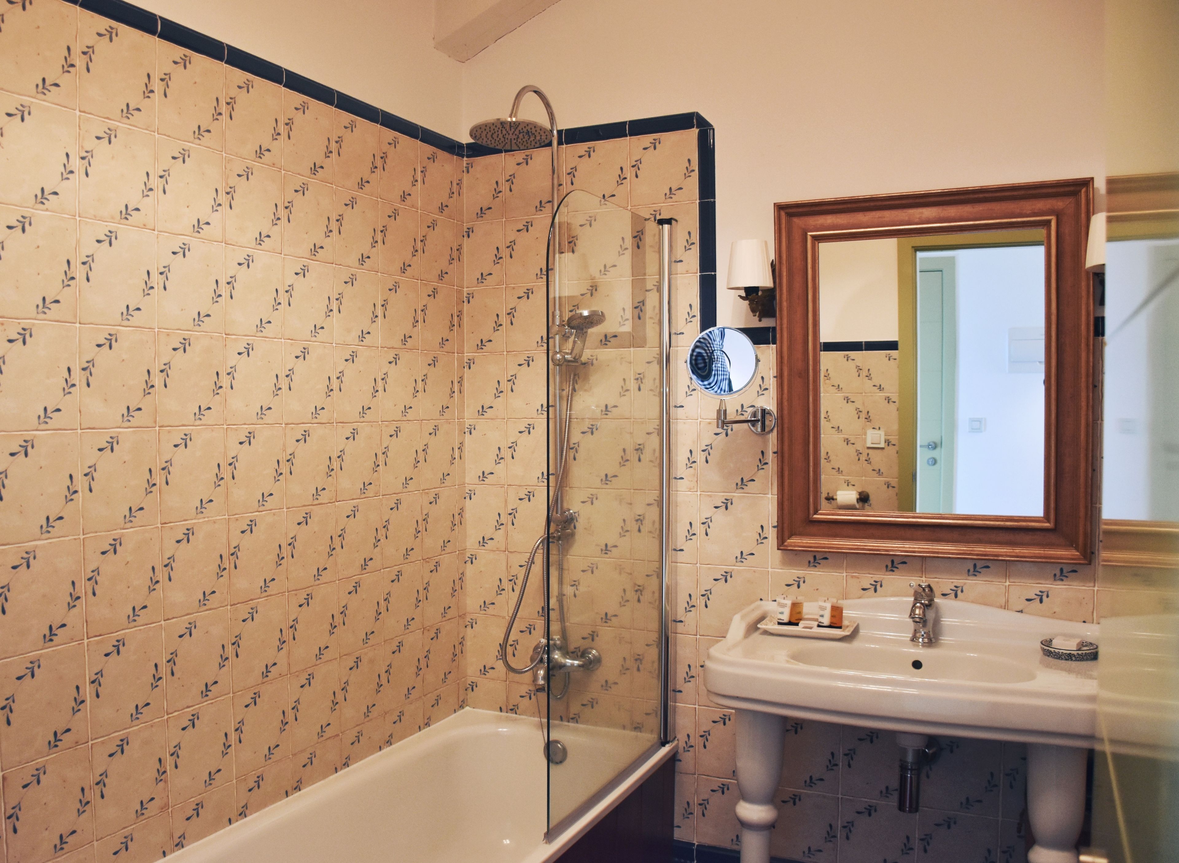 Baño con ducha, lavabo y espejo.