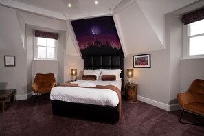A bedroom with a large bed, two bedside tables, a nightstand, a chair, and a ceiling mural. - Wanslea Guest House (Ambleside)