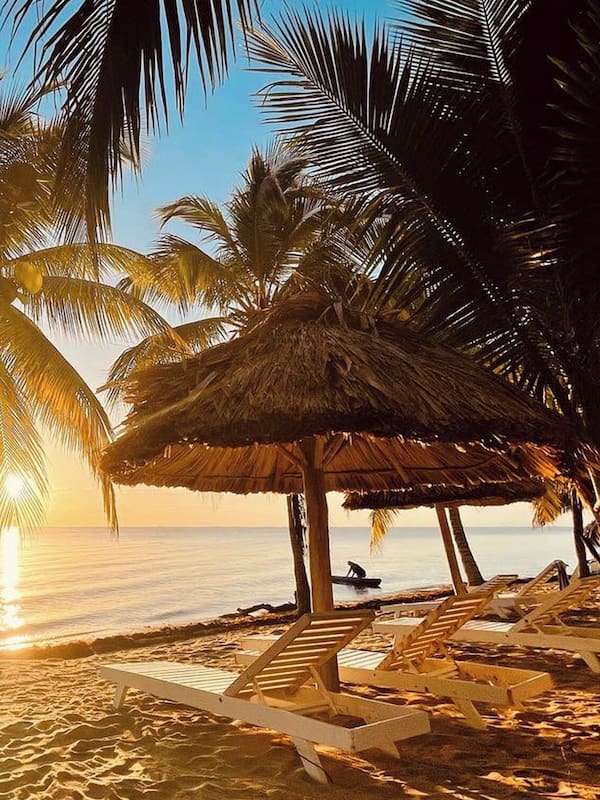 On the beach, white sand, sun loungers, beach umbrellas