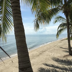 On the beach, white sand, sun loungers, beach umbrellas