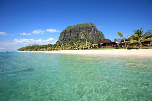 On the beach, white sand, sun-loungers, beach umbrellas