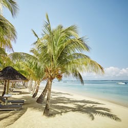 On the beach, white sand, sun loungers, beach umbrellas