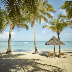 On the beach, white sand, sun loungers, beach umbrellas
