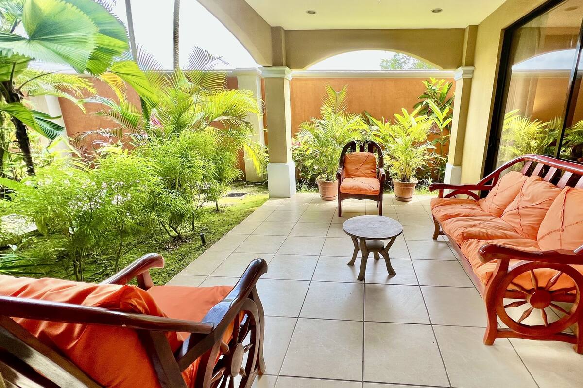 A patio area with a sofa, chairs, and a small table.