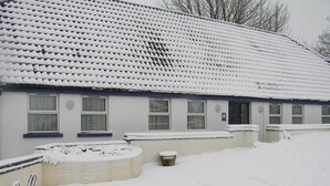 A building with a tiled roof, multiple windows, and a snow-covered ground. - The Well guesthouse (Marlborough)