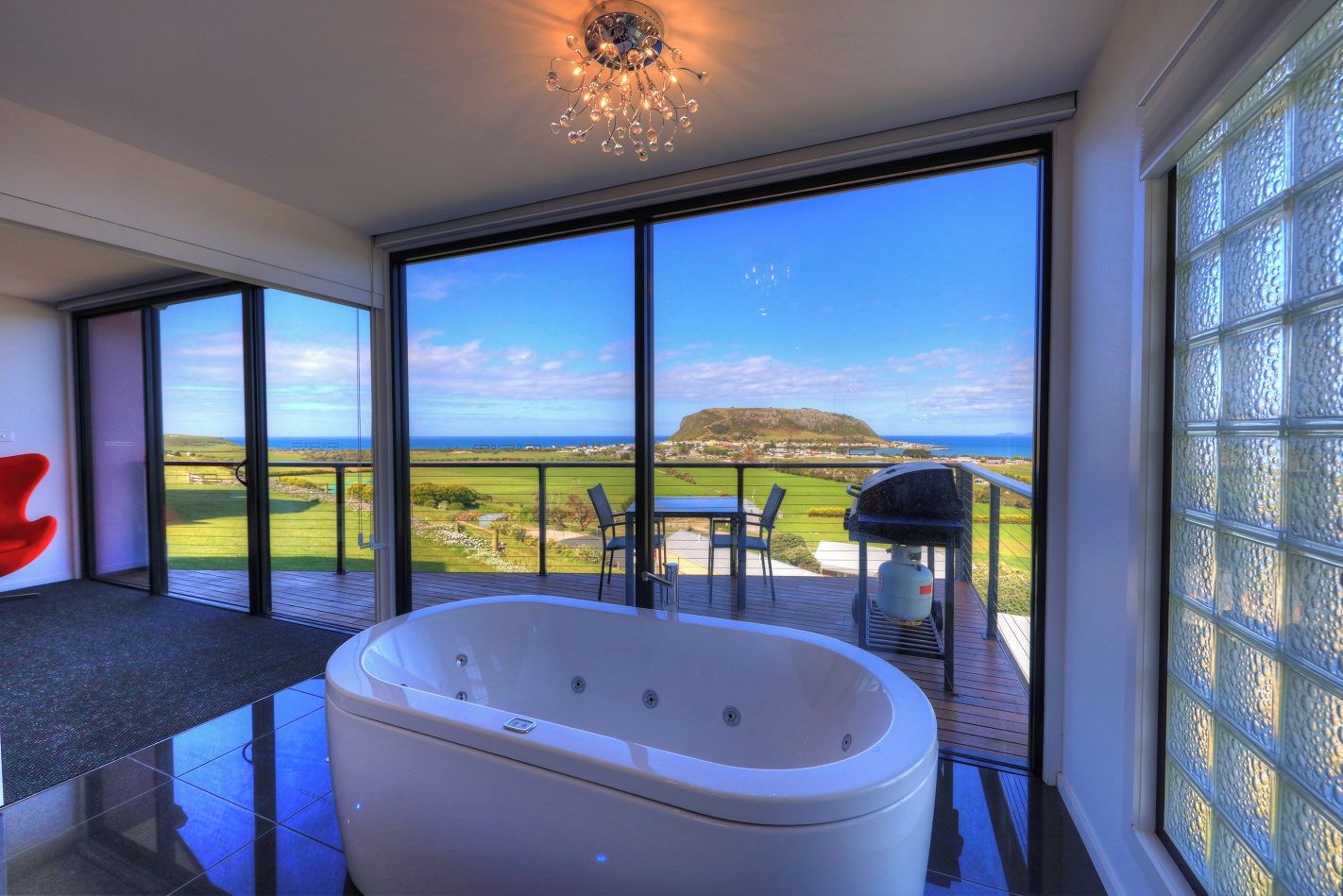 A modern bathroom with a large bathtub, a shower, and a glass-enclosed shower area.