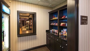 A hotel corridor with a minibar, a mirror, and a 'Suite Shop' sign. - Hampton Inn & Suites Danville (Danville)
