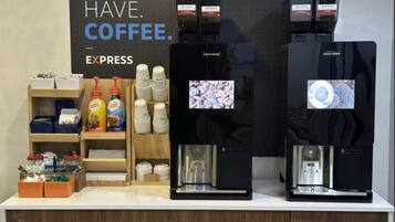 A coffee station with two espresso machines and a sign that reads "MUST. HAVE. COFFEE."