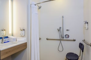 Enjoy a refreshing shower with a handheld showerhead and faucet, plus a convenient grab bar for support.