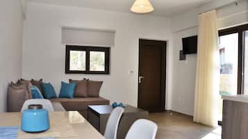Un soggiorno moderno con un divano, un tavolino da caffè e una TV a parete.