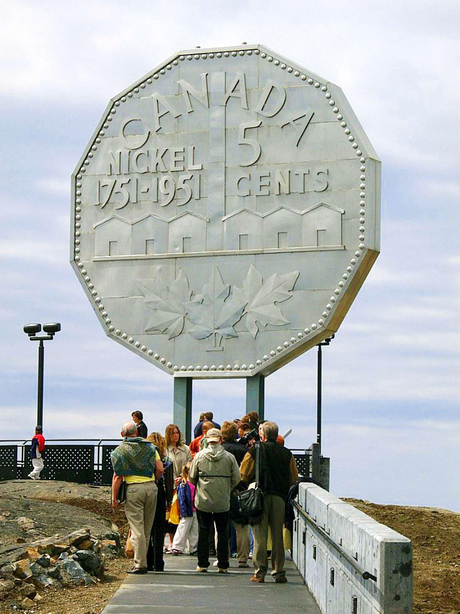 A large sign with the text "Canada Nickel 1951 Cents" and a maple leaf design.
