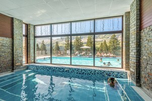 Una piscina al aire libre de temporada, sombrillas