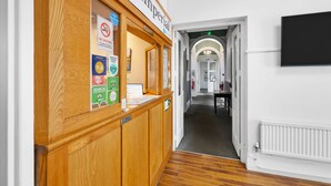 A reception area with a wooden counter, a sign reading "The Imperial," and a no smoking sign. - Imperial Plymouth (Plymouth)