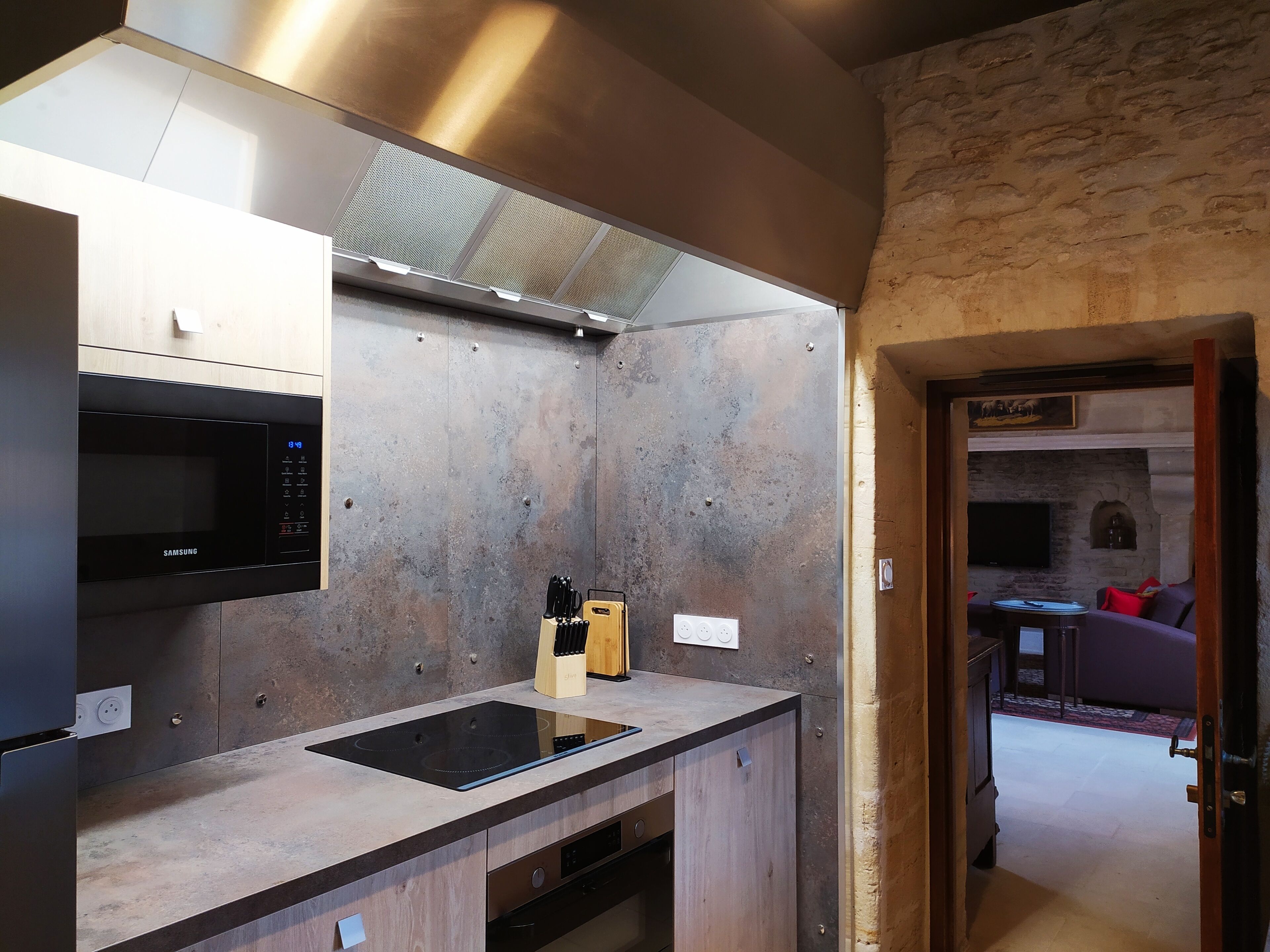 A modern kitchen with a built-in microwave, an induction cooktop, and a dishwasher.