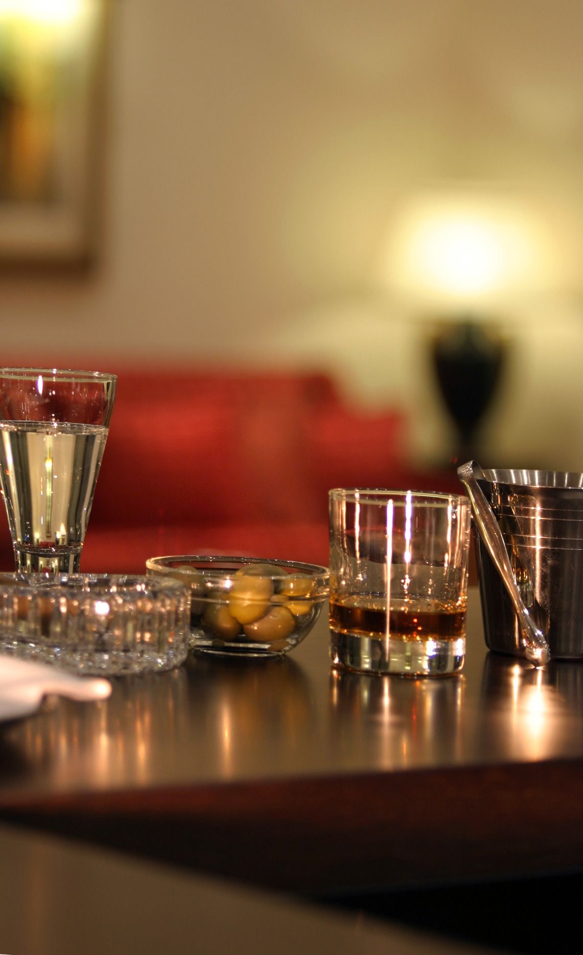 A bar area with various glasses and a bowl of olives.
