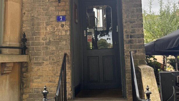 A stone building with a sign reading "REGENCY HOUSE GUEST HOUSE" above the entrance. - Regency Guest House (Cambridge)