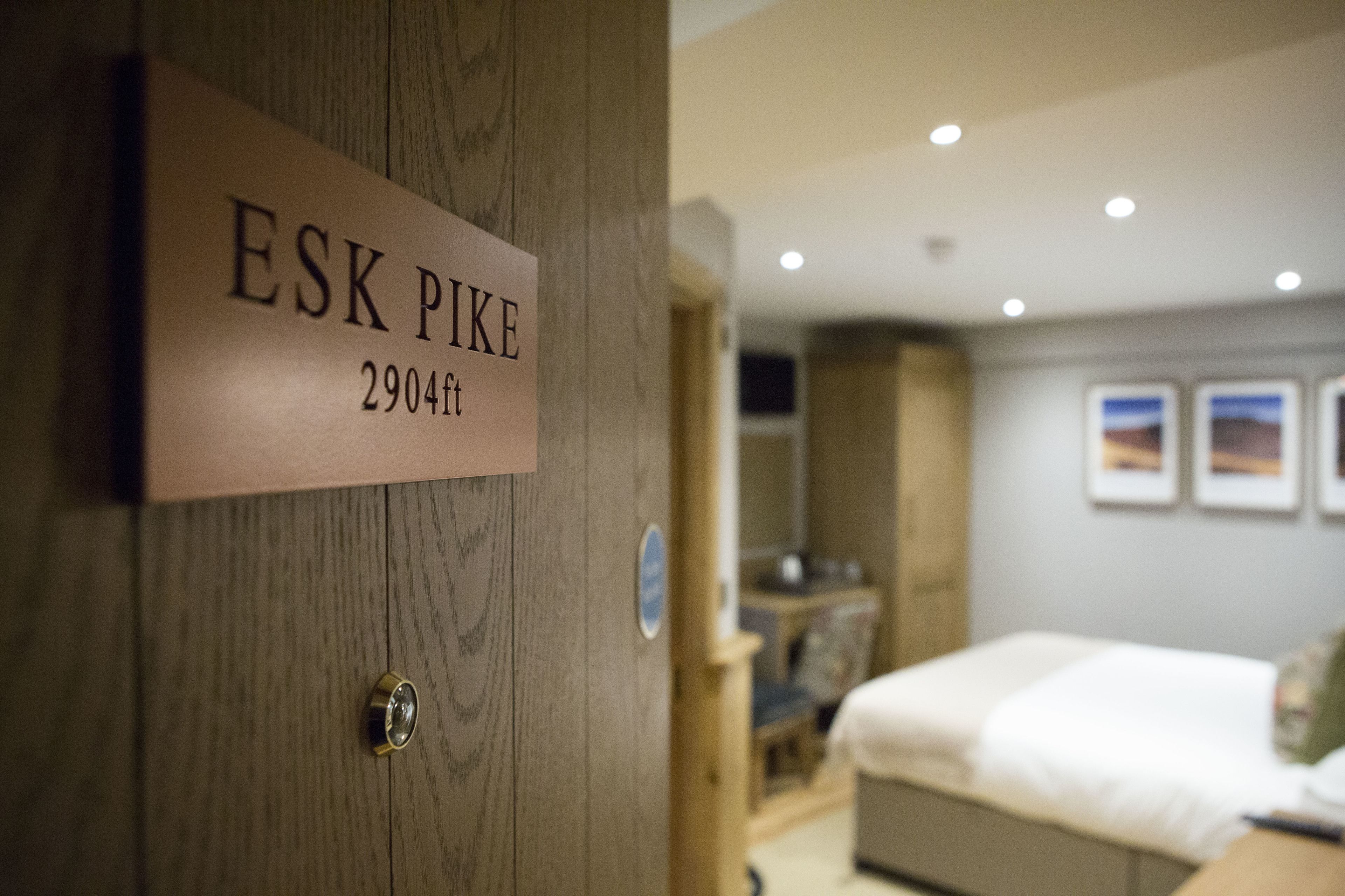 Una puerta de madera con una placa que dice "ESK PIK" y el número de habitación "2904ft".