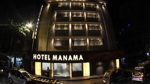 A multi-story hotel with a prominent sign reading "HOTEL MANAMA". - Hotel Manama (Mumbai)