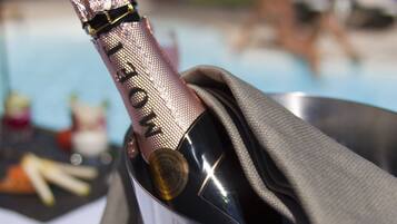 A bottle of champagne in a metal container with a cloth napkin.